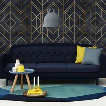 BlackandGoldGeometricWallpaper living room setting with matching navy blue sofa.