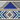 On a wall is a Zulu inspired wallpaper with a geometric repeat pattern of triangles and diamond shapes. Colours light blue, navy blue, black and white. 