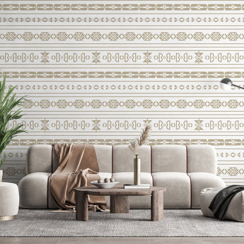 Sepedi inspired wallpaper with various geometric shapes. Background of the wallpaper is cream white, with  shapes in a beige colour on a wall in a  living room setting.