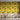 Coffee shop setting with chairs and tables. On the wall is a Tsonga inspired wallpaper. Wallpaper pattern of a colourful floral pattern of yellow flowers and red flowers with green leaves, on a background of yellow and white vertical stripes.