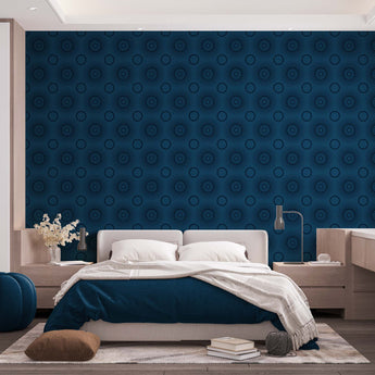 A bedroom with complete bedroom furniture and bedding. On the one wall is a wallpaper with a blue background and navy circles.